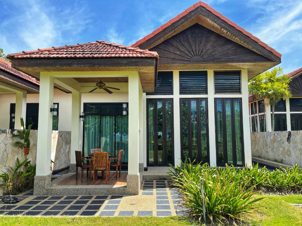 Villa exterior with lush garden and terrace